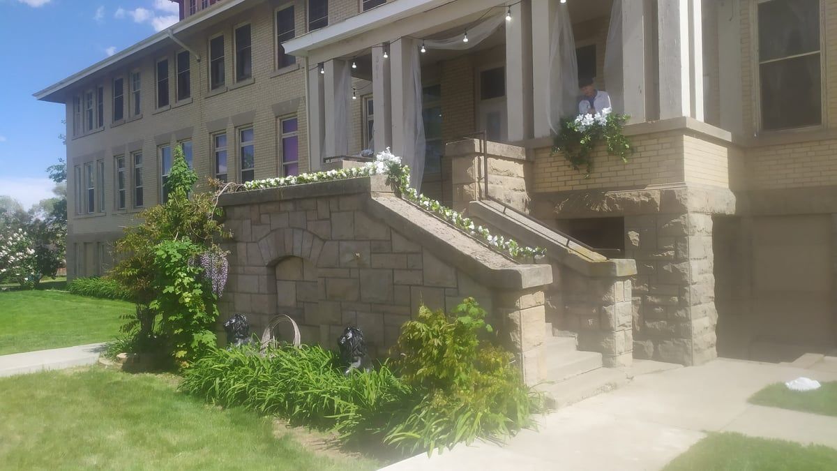Stone entrance and brick facade of the Gooding University Inn, the former Gooding College